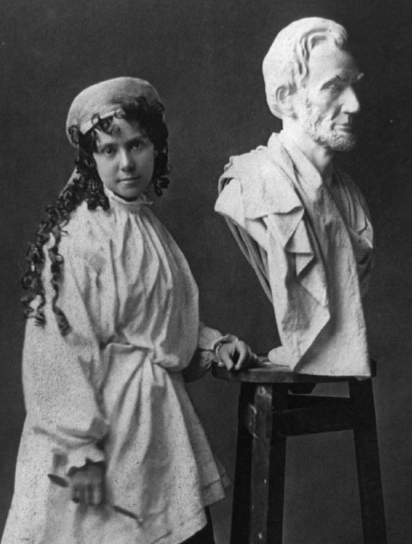 Vinnie Ream standing beside her bust of Abraham Lincoln